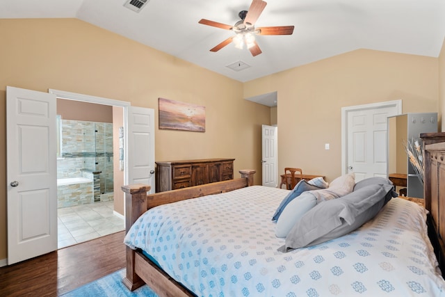 bedroom featuring wood-type flooring, ensuite bathroom, lofted ceiling, and ceiling fan