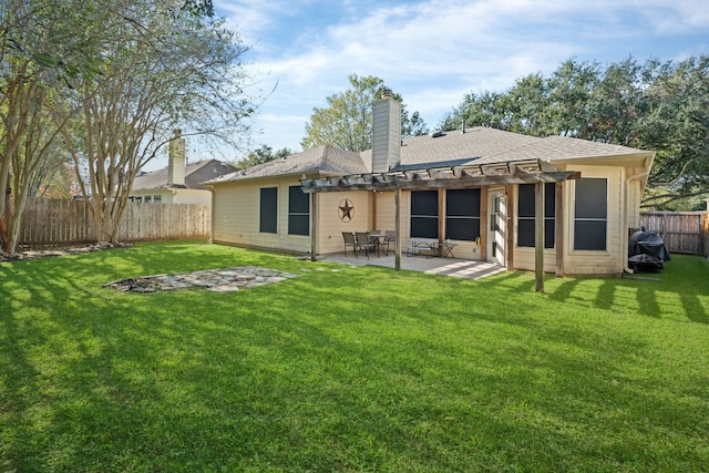 back of house featuring a patio area and a yard