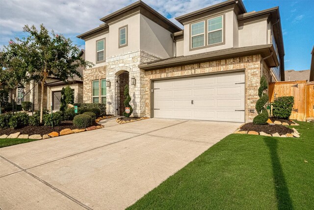 view of front of house with a front yard and a garage