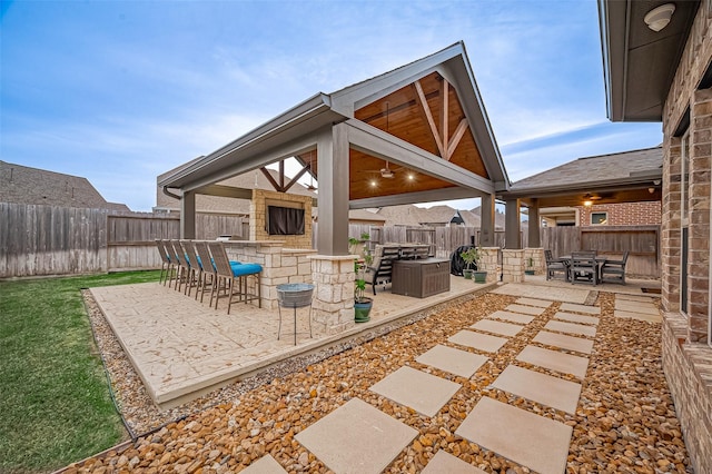 view of patio / terrace with a gazebo, ceiling fan, and an outdoor bar