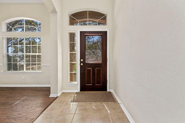 entryway featuring light tile patterned floors and baseboards