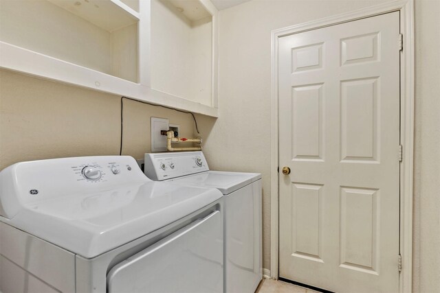 washroom featuring laundry area and washer and clothes dryer