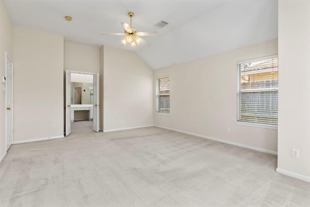 unfurnished bedroom with lofted ceiling, carpet, visible vents, and baseboards