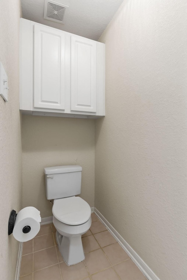 bathroom with tile patterned flooring, visible vents, and baseboards