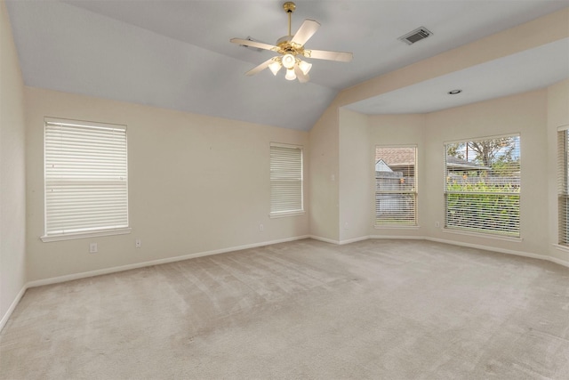 carpeted empty room featuring ceiling fan, visible vents, and baseboards