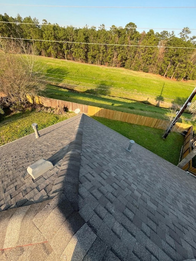 exterior space featuring roof with shingles