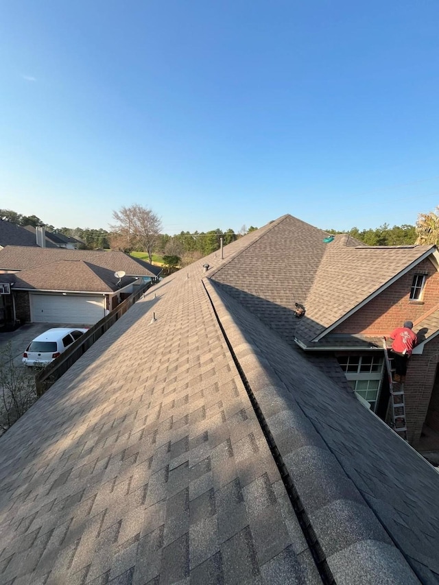 details featuring roof with shingles