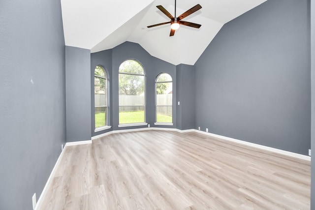 unfurnished room with ceiling fan, lofted ceiling, and light hardwood / wood-style flooring