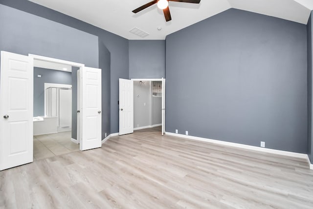 unfurnished bedroom featuring ceiling fan, vaulted ceiling, and light wood-type flooring