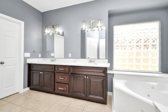 bathroom with tile patterned flooring, vanity, and a bathing tub