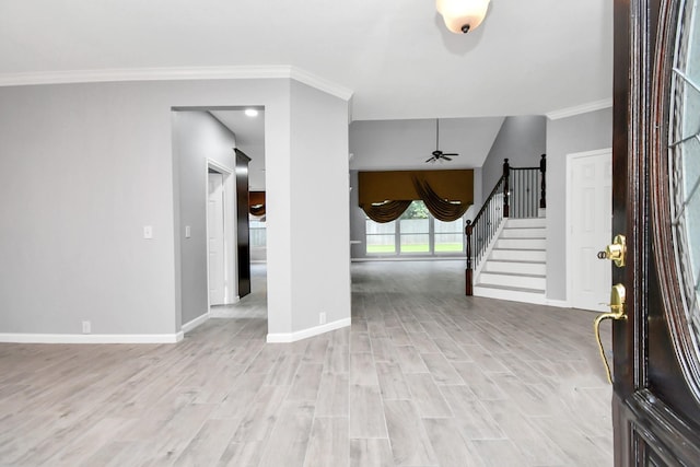 entryway with light wood-type flooring, ceiling fan, and ornamental molding