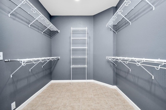 walk in closet featuring tile patterned flooring