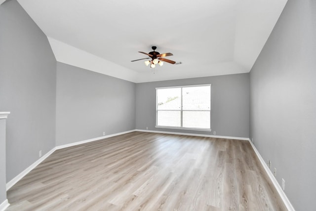 unfurnished room with ceiling fan, light wood-type flooring, and lofted ceiling