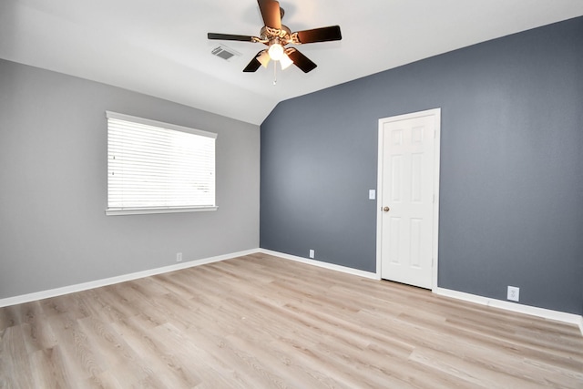 spare room featuring light wood-type flooring, ceiling fan, and lofted ceiling