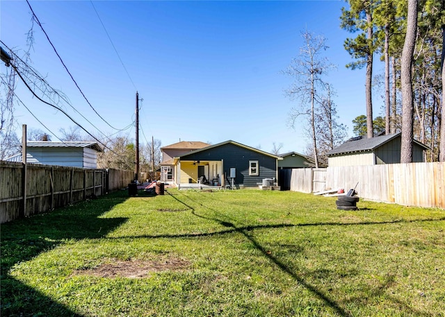 back of house featuring a yard and ceiling fan