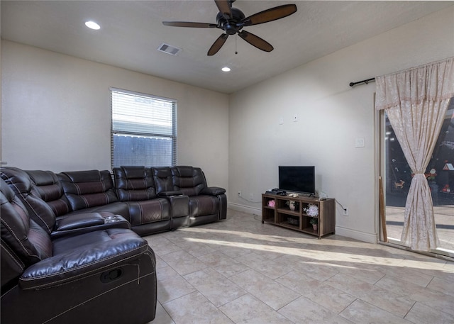 living room with ceiling fan and light tile patterned floors