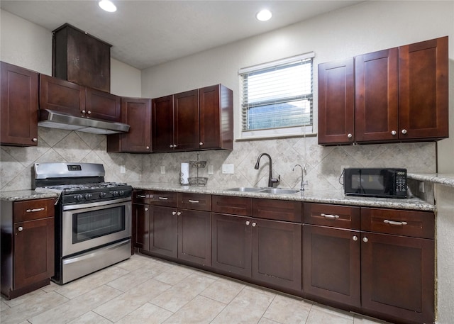 kitchen with tasteful backsplash, light stone countertops, sink, and stainless steel range with gas stovetop