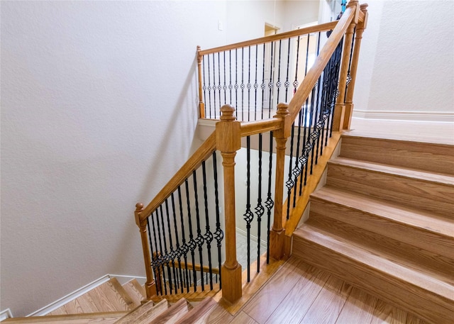 stairs featuring hardwood / wood-style flooring