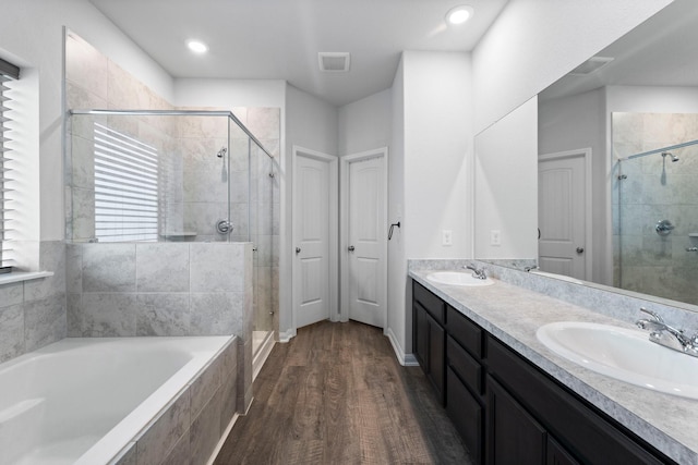 bathroom featuring shower with separate bathtub, vanity, and hardwood / wood-style flooring