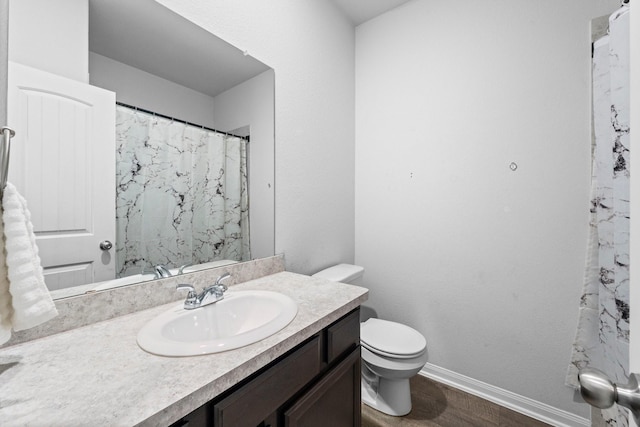 bathroom featuring hardwood / wood-style floors, vanity, and toilet