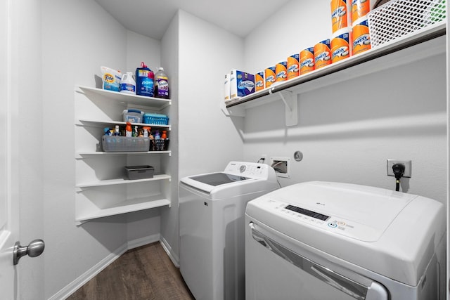 laundry room featuring dark hardwood / wood-style flooring and washer and clothes dryer