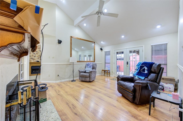 living room with light hardwood / wood-style flooring, high vaulted ceiling, french doors, and ceiling fan