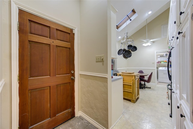 foyer with washer / clothes dryer and vaulted ceiling