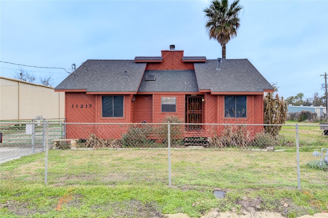 rear view of property featuring a yard