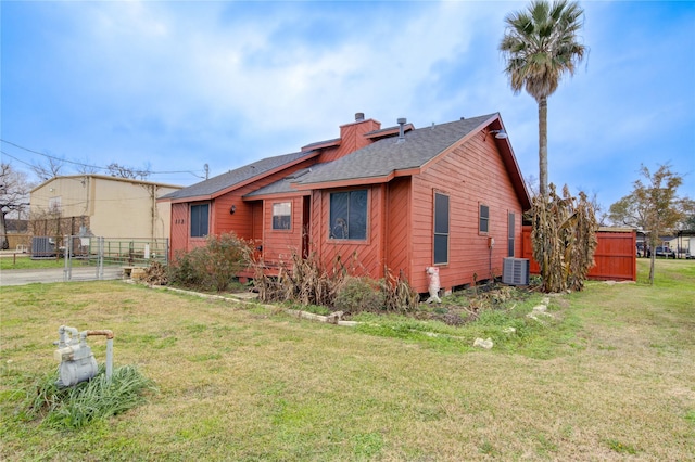 view of property exterior featuring a yard and central AC unit