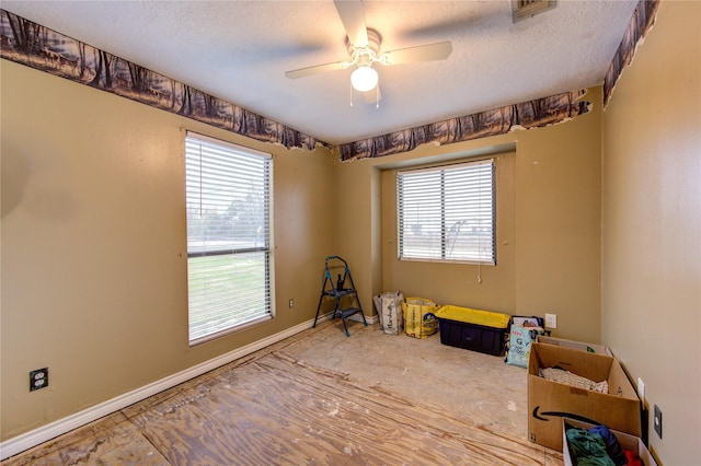 miscellaneous room featuring ceiling fan and a textured ceiling