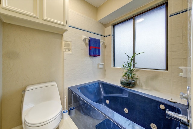 bathroom with a bathtub, tile patterned floors, and toilet