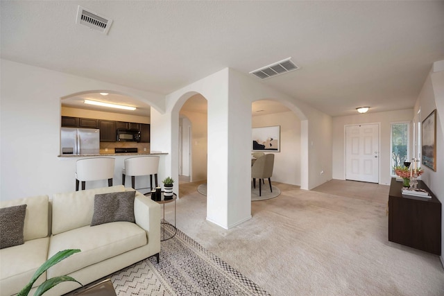 living room featuring light carpet