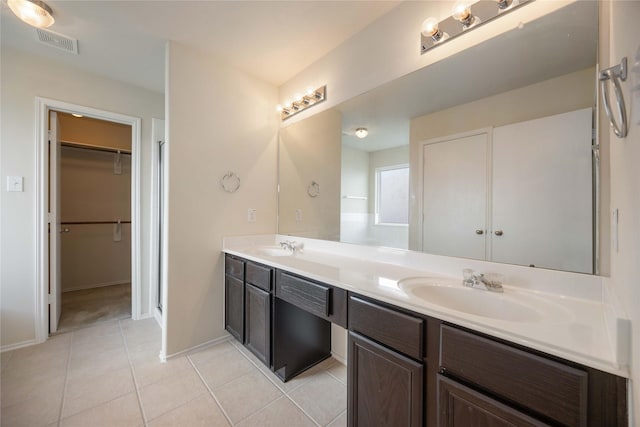 bathroom with tile patterned floors and vanity