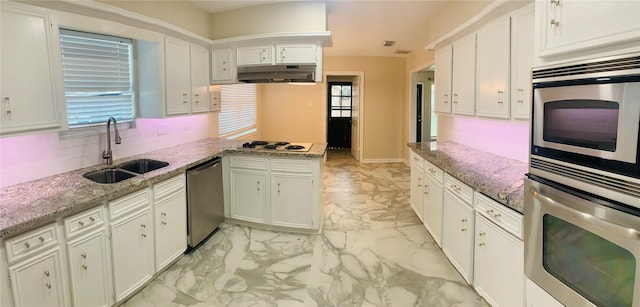 kitchen with white cabinetry, stainless steel appliances, and sink