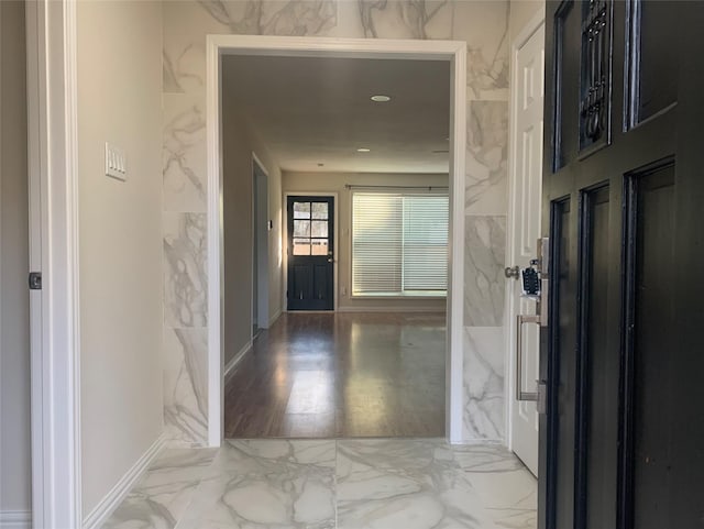 hallway featuring tile walls