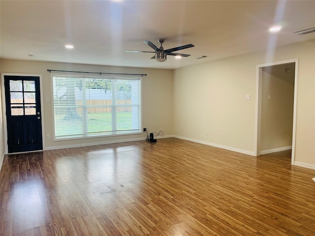 spare room with ceiling fan and hardwood / wood-style flooring