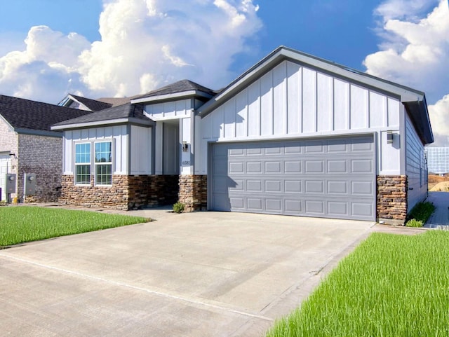 view of front of home with a garage and a front lawn