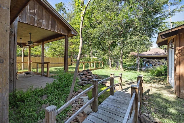 view of yard featuring an outdoor fire pit and ceiling fan