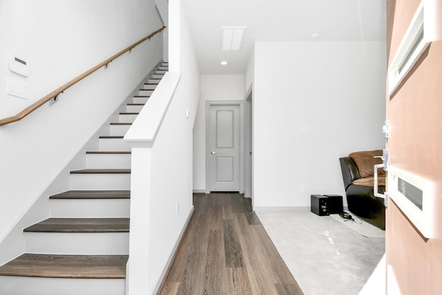 stairway with hardwood / wood-style flooring