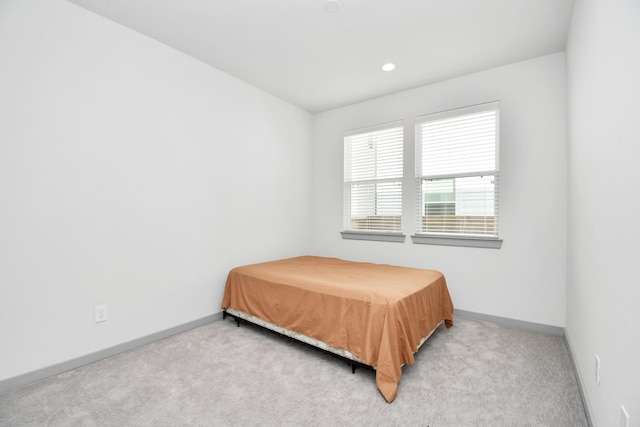 bedroom featuring light colored carpet