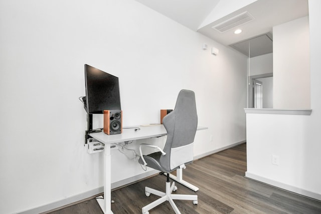 home office featuring dark wood-type flooring and vaulted ceiling