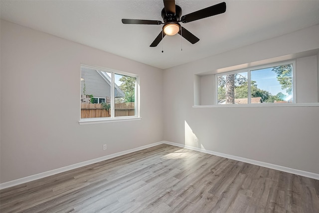 unfurnished room featuring ceiling fan and light wood-type flooring