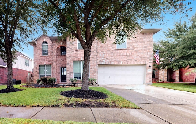 view of property with a garage and a front lawn