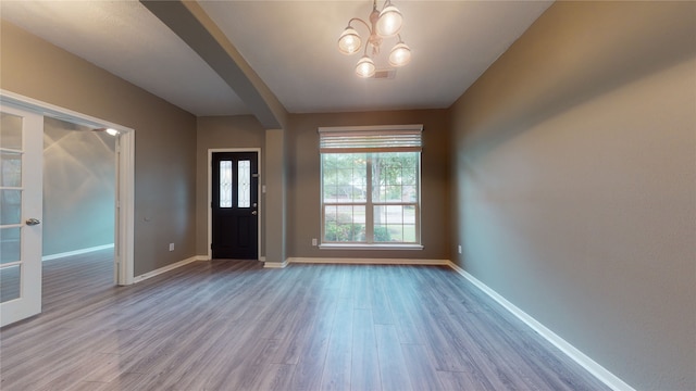 entryway featuring light hardwood / wood-style flooring and a notable chandelier