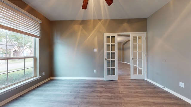 empty room featuring hardwood / wood-style flooring, ceiling fan, and french doors