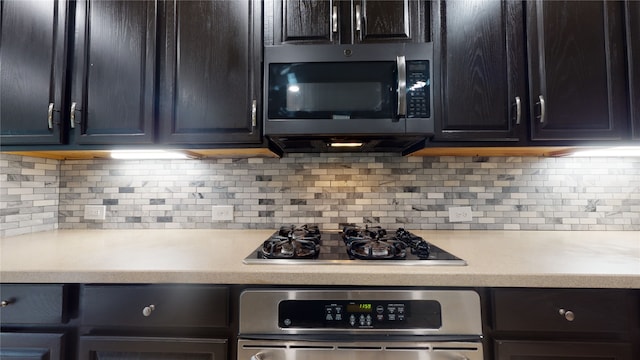 kitchen featuring backsplash, gas stovetop, and oven