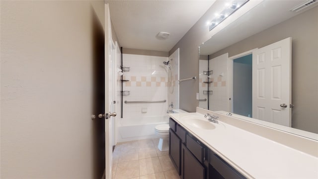 full bathroom with tile patterned flooring, tiled shower / bath combo, toilet, and vanity