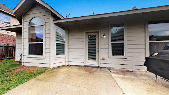 view of exterior entry featuring a patio