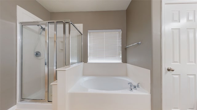 bathroom with shower with separate bathtub