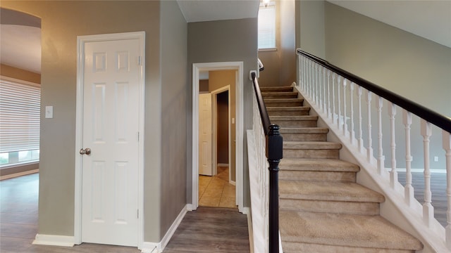 stairs with hardwood / wood-style flooring